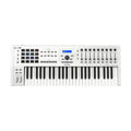 White music keyboard controller with multiple keys, pads, knobs, faders, buttons, and a small display screen.