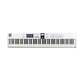 White MIDI keyboard controller with 88 keys, pads, buttons, knobs, faders, display screen, and wheel controllers.
