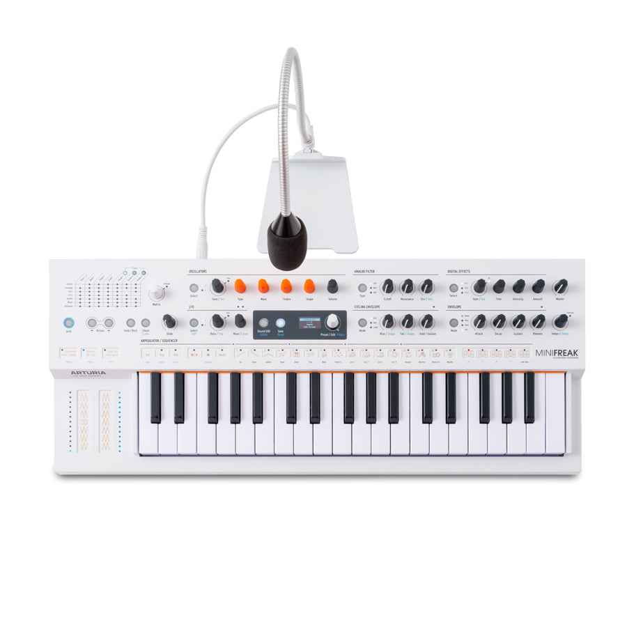 White compact keyboard synthesizer with knobs, buttons, display, and a microphone attached by a flexible arm.
