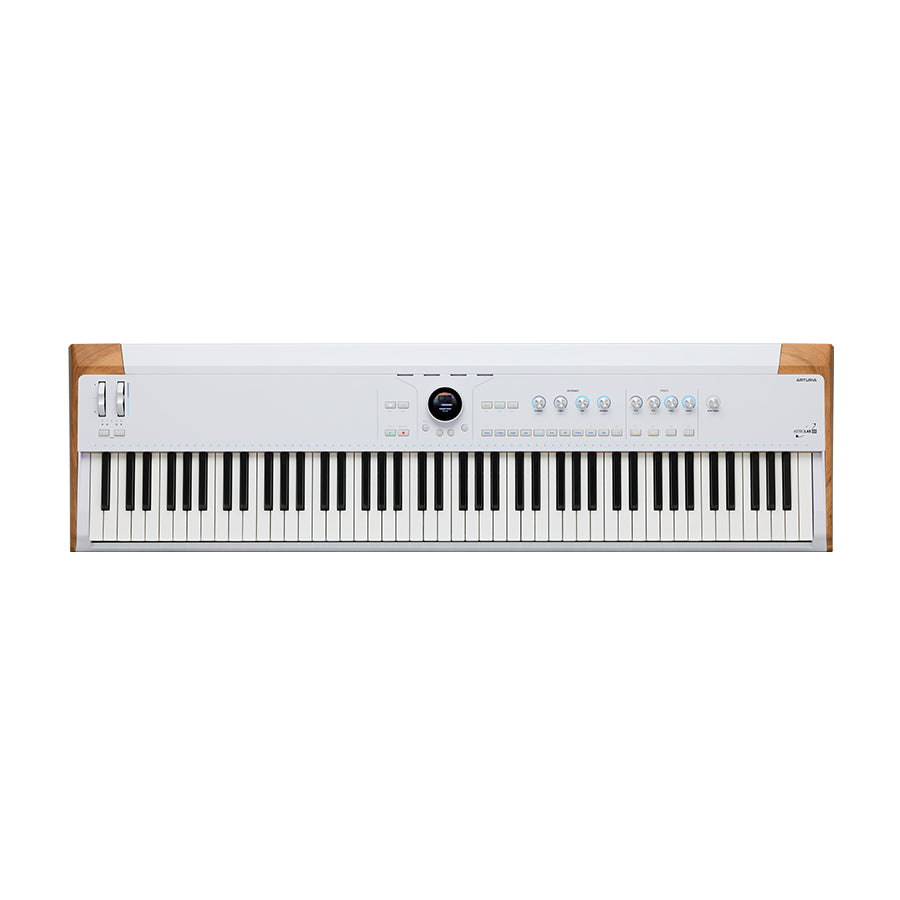 White and wood digital keyboard synthesizer with 88 keys, control knobs, buttons, and wheels on top panel.
