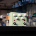 Seafoam green guitar delay pedal with white knobs and two footswitches labeled Bypass and Tap/Hold.