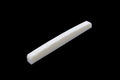 White elongated curved part with slotted notches on a black background.