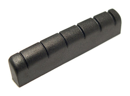 Black slotted guitar nut with six string slots on a plain white background.