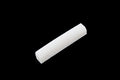White slotted bone nut for guitar, shown on black background.