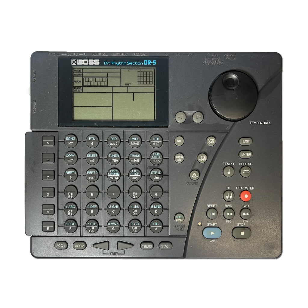 Top view of a Boss Dr. Rhythm Section DR-5 drum machine with numerous buttons, rotary knob, and a display screen.