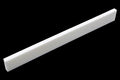 White rectangular bone or synthetic guitar saddle blank on a black background.
