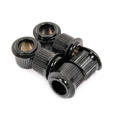 Six black metal cylindrical conversion bushings with knurled edges arranged in a cluster on a white background.