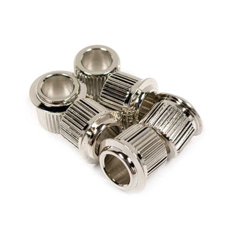Six silver metal cylindrical bushings with ridged sides arranged on a white background.
