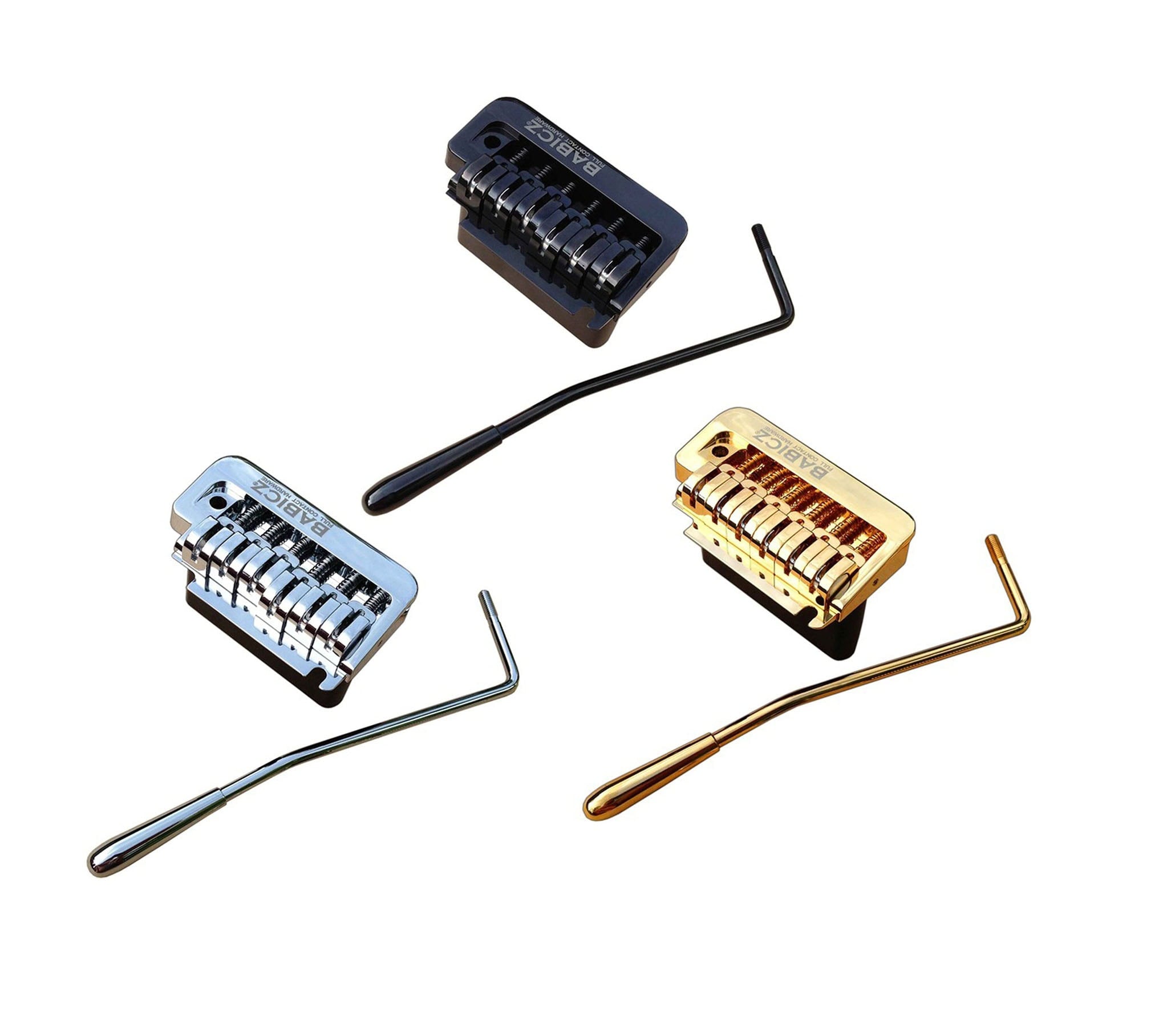 Three guitar bridge units in black, silver, and gold with matching tremolo arms arranged on a white background.