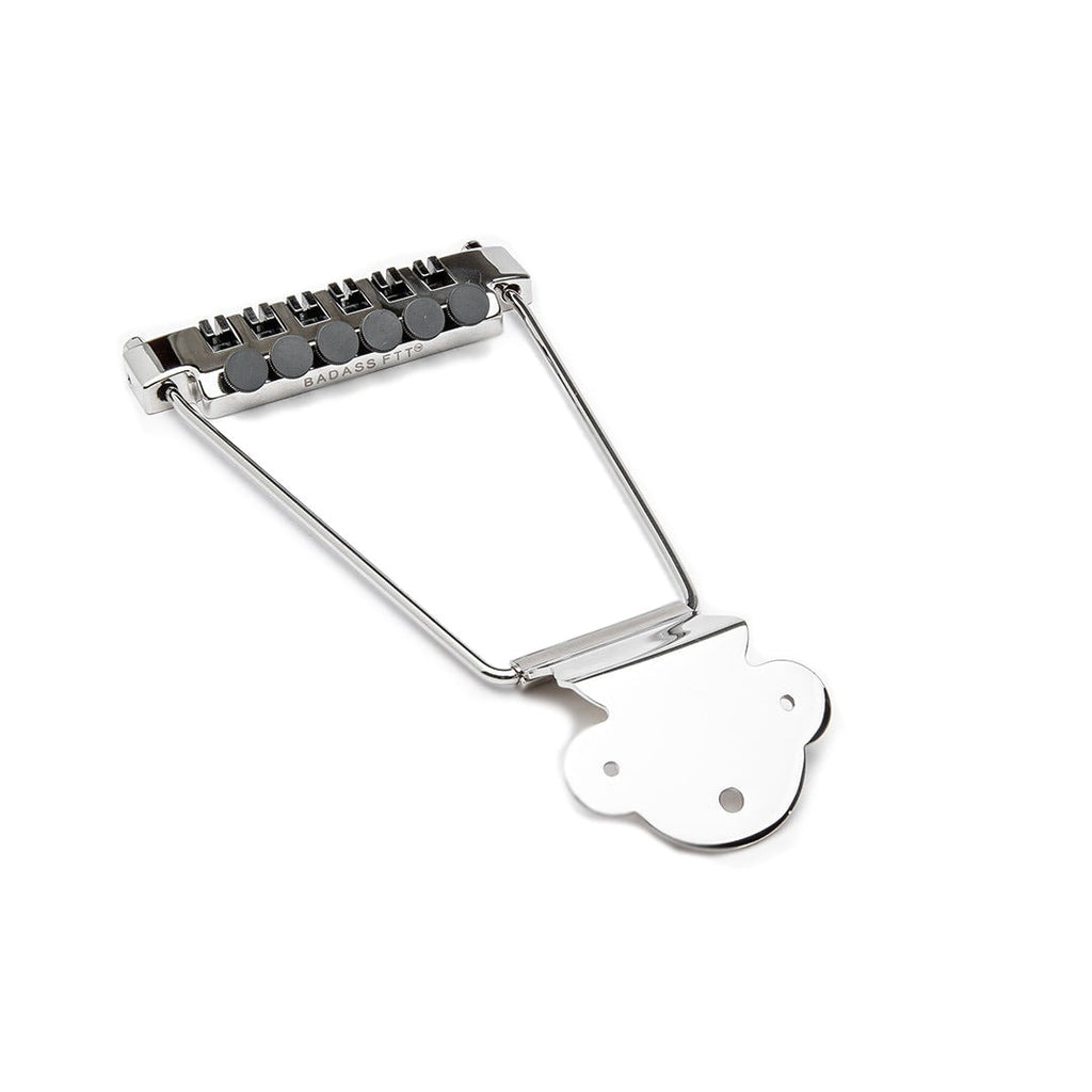 Nickel-colored trapeze tailpiece with fine tuners for guitar strings labeled BADASS FTT