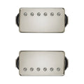Two silver rectangular humbucker guitar pickups with black wires on a white background.