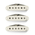 Three off-white single coil pickups with six metal pole pieces each and attached wire leads.