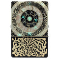 Rectangular device with intricate abstract designs featuring iridescent and gold patterns on a black background.
