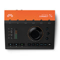 Top view of an orange and black audio interface with multiple jack ports, buttons, and a central large rotary knob.
