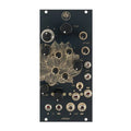 Black eurorack module panel with gold lotus design, knobs, toggle switch, and multiple 3.5mm jacks labeled with audio terms.