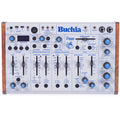 Top view of a Buchla Ziggy analog desktop synthesizer with wooden side panels and blue control knobs and sliders.