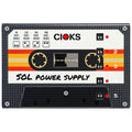 Black rectangular pedal power supply unit with cassette-style design and multiple dip switches labeled 1 to 5.