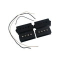 Two black electric bass pickups with attached black and white wires on a white background.