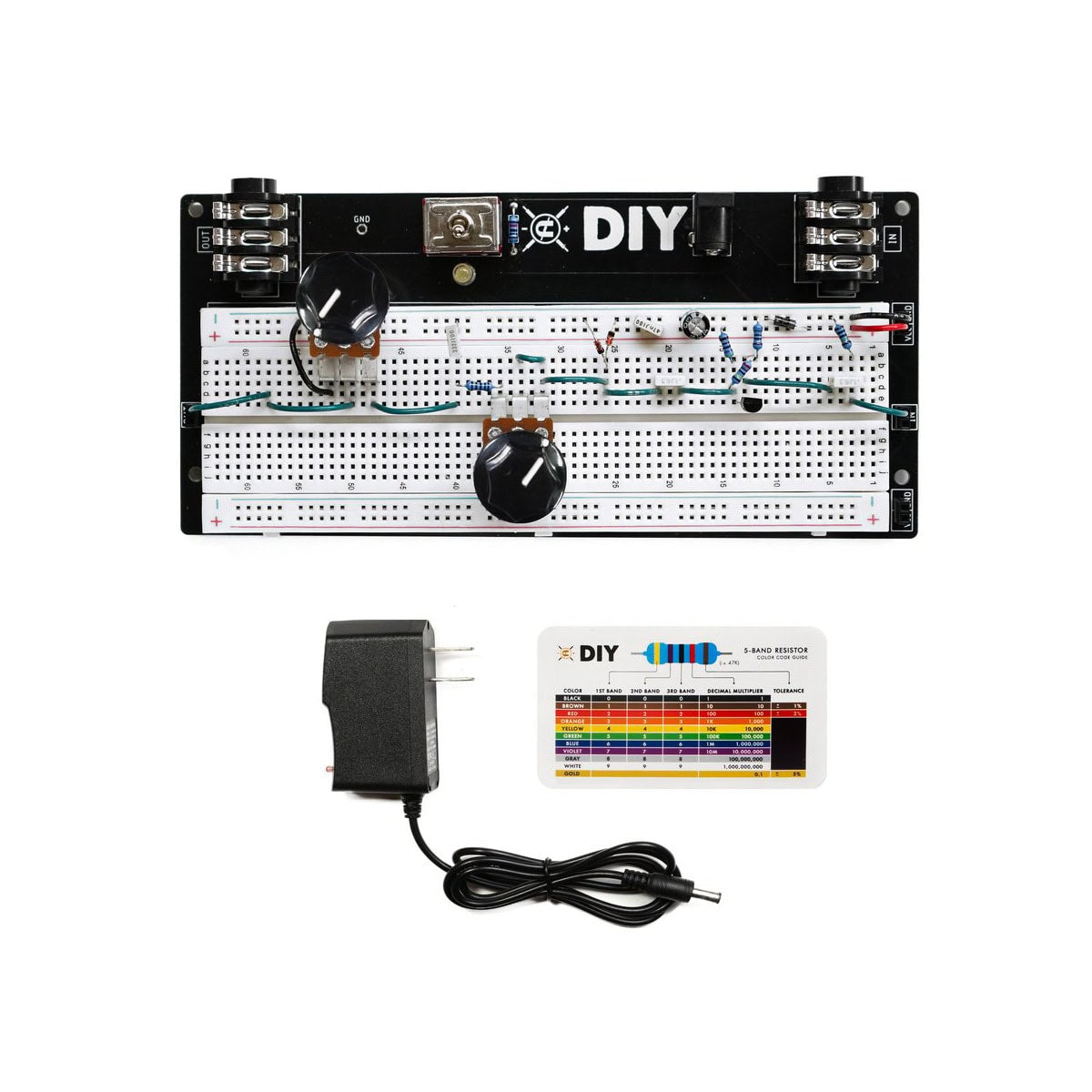 Electronic breadboard kit with components, power adapter, and resistor color code guide card.