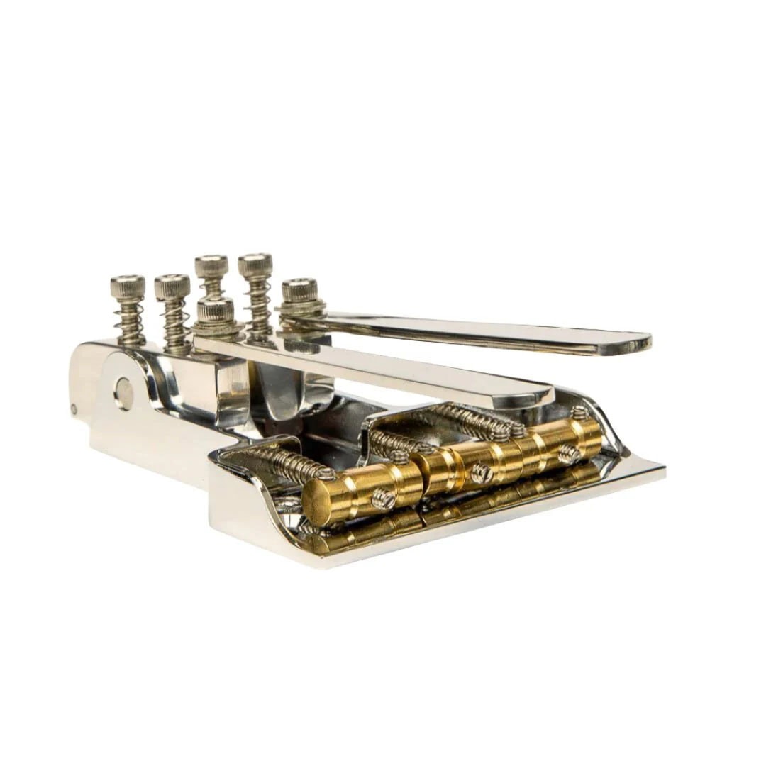 Nickel and gold metal guitar bridge with five adjustment screws and string saddles.