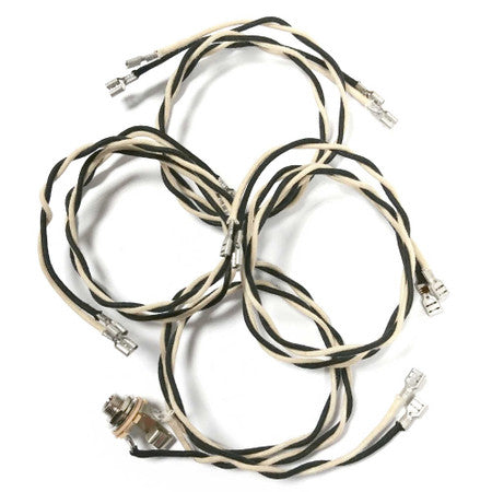 Wiring harness with multiple black and white insulated wires and metal spade connectors.