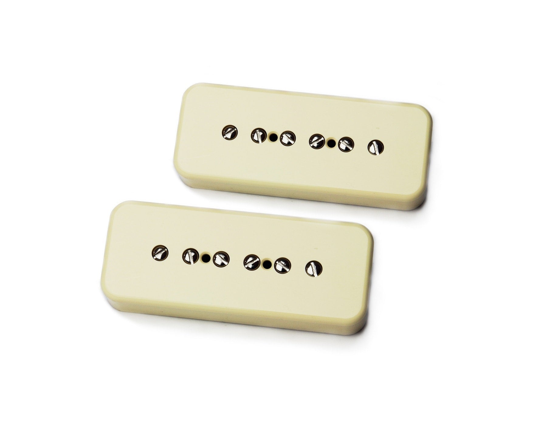 Two cream-colored rectangular guitar pickups with six metal pole pieces each.