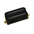 Black dual-coil guitar pickup with gold mounting base on white background.