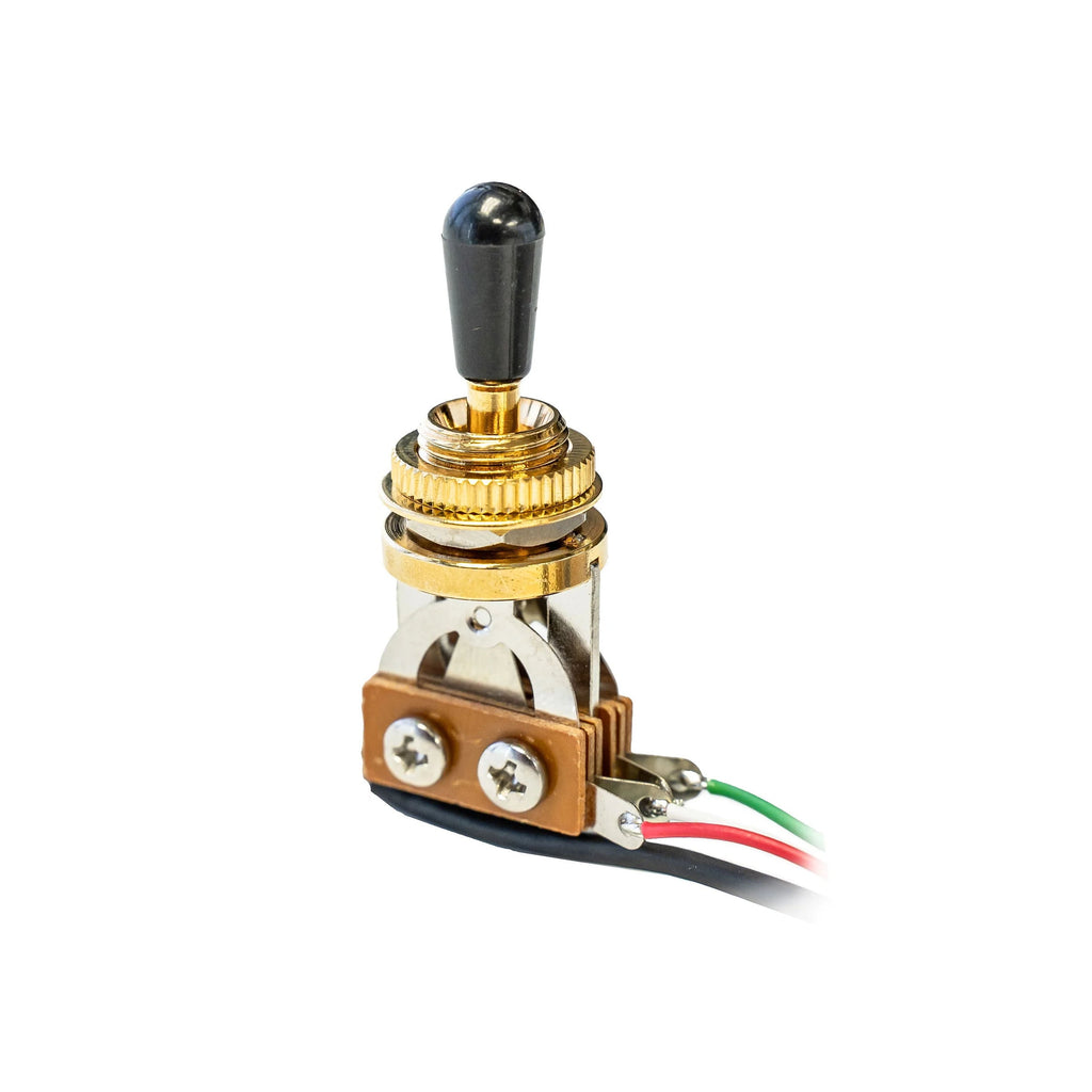 Gold toggle switch with black tip mounted on a metal bracket with red, green, and black wires attached.