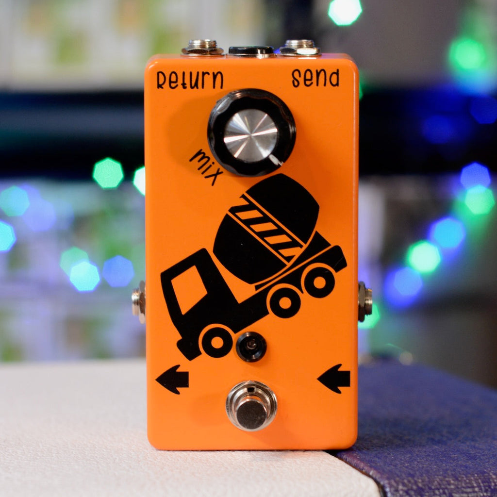 Orange rectangular device with a concrete mixer graphic, one knob labeled mix, two jacks labeled return and send, and a footswitch.