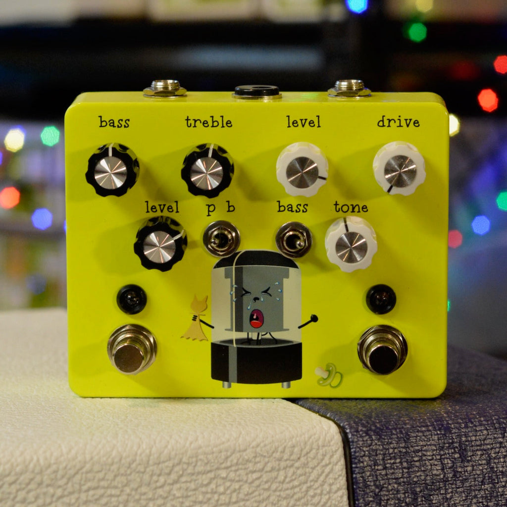 Yellow guitar effects pedal with multiple knobs, two toggle switches, two footswitches, and cartoon shower graphic.
