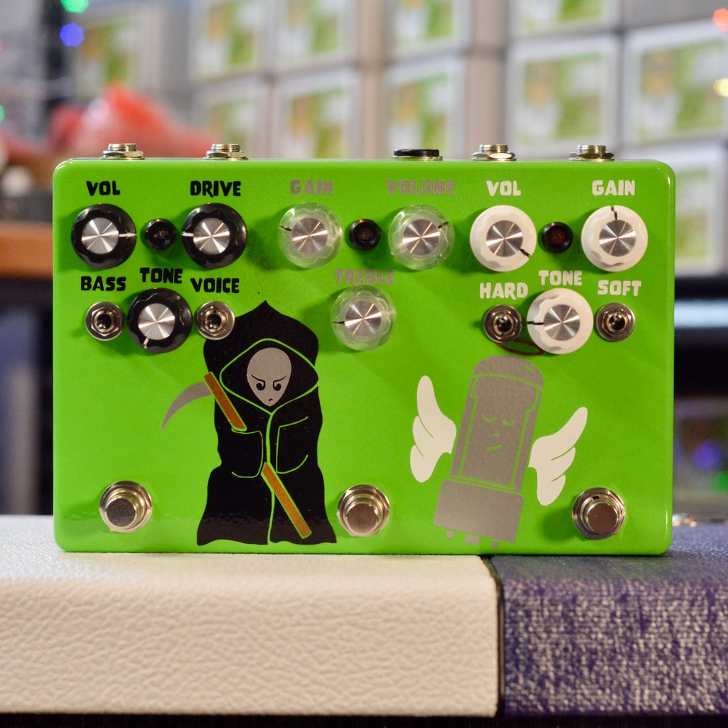Green guitar effects pedal with multiple knobs, toggle switches, footswitches, and illustrations of a grim reaper and a winged tube.