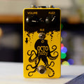 Yellow and black guitar effects pedal with octopus graphic and controls labeled Volume and Fuzz.