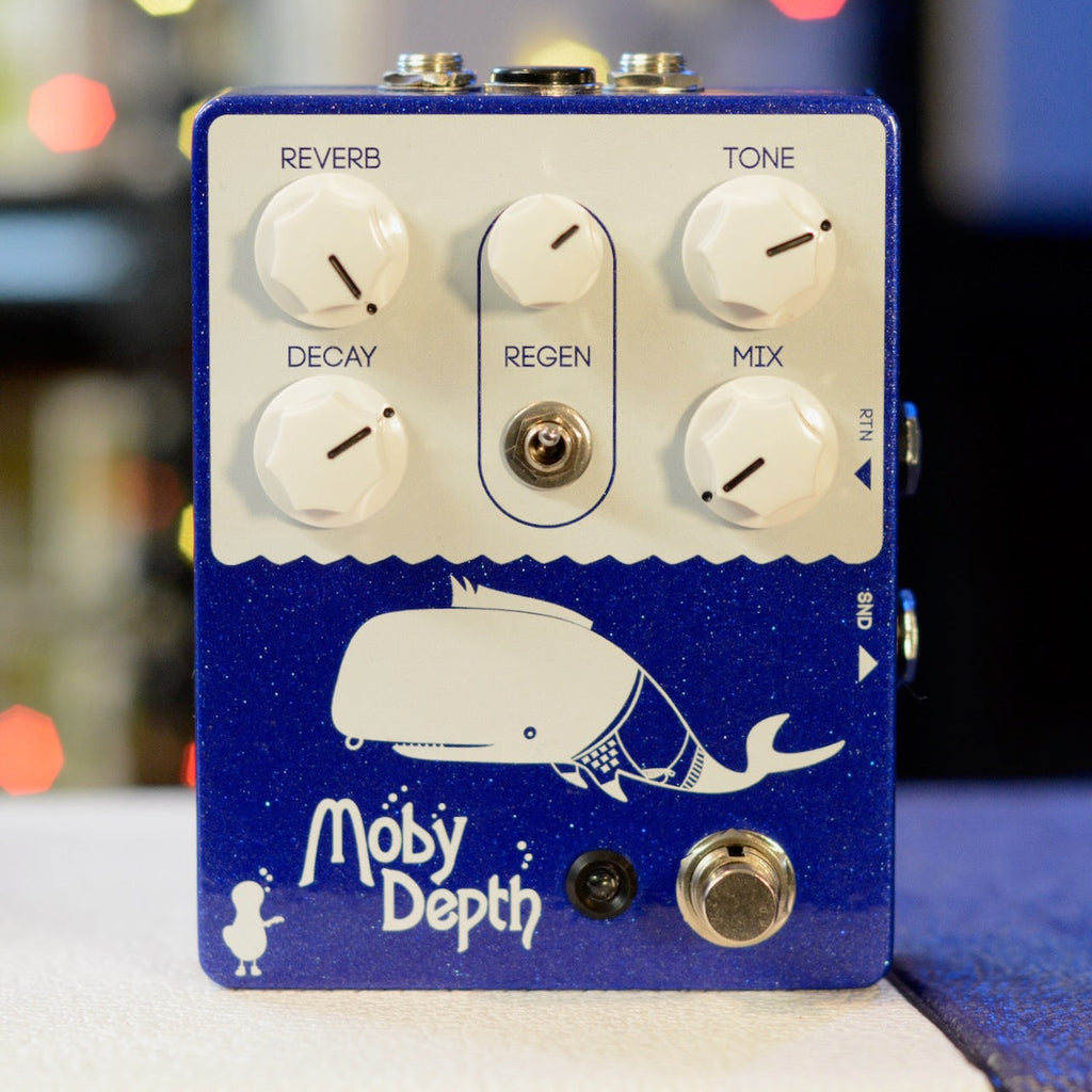 Blue pedal with white knobs and whale graphic labeled Moby Depth and controls for reverb, decay, regen, tone, and mix.
