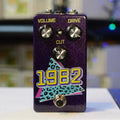 Purple guitar effects pedal with three control knobs labeled Volume, Drive, and Cut, and a footswitch below.