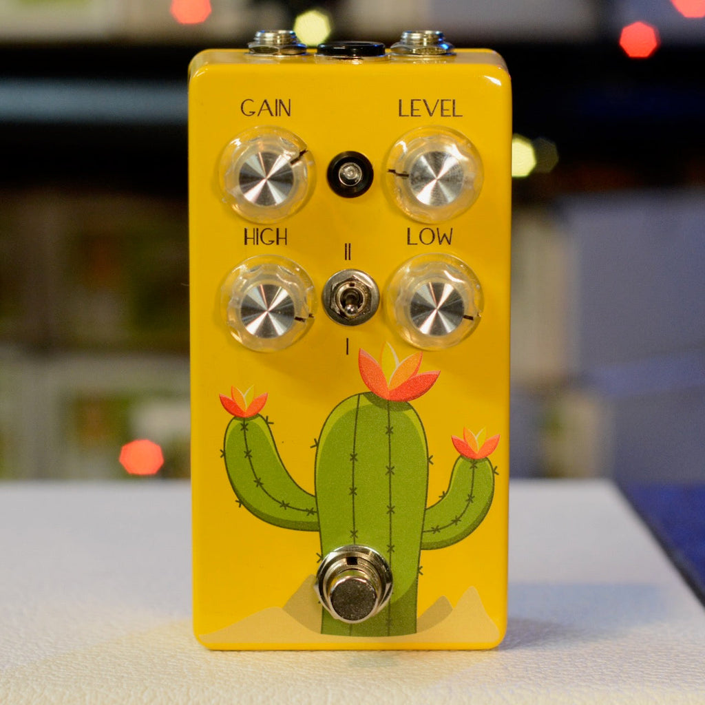 Yellow guitar effects pedal with cactus illustration, four knobs, toggle switch, and footswitch