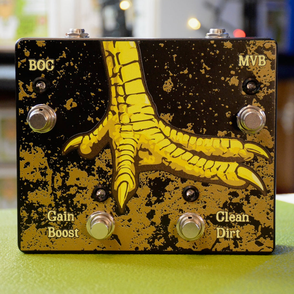 Black and gold pedal with a large yellow bird claw graphic and four footswitches labeled BOG, MVB, Gain Boost, and Clean Dirt.
