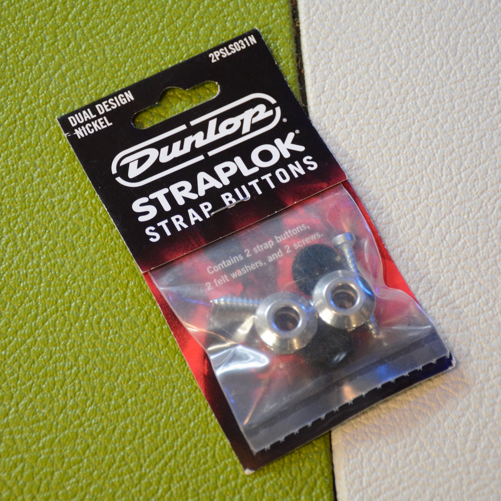 Package of Dunlop Straplok strap buttons showing two metal buttons, screws, and felt washers inside plastic pouch.