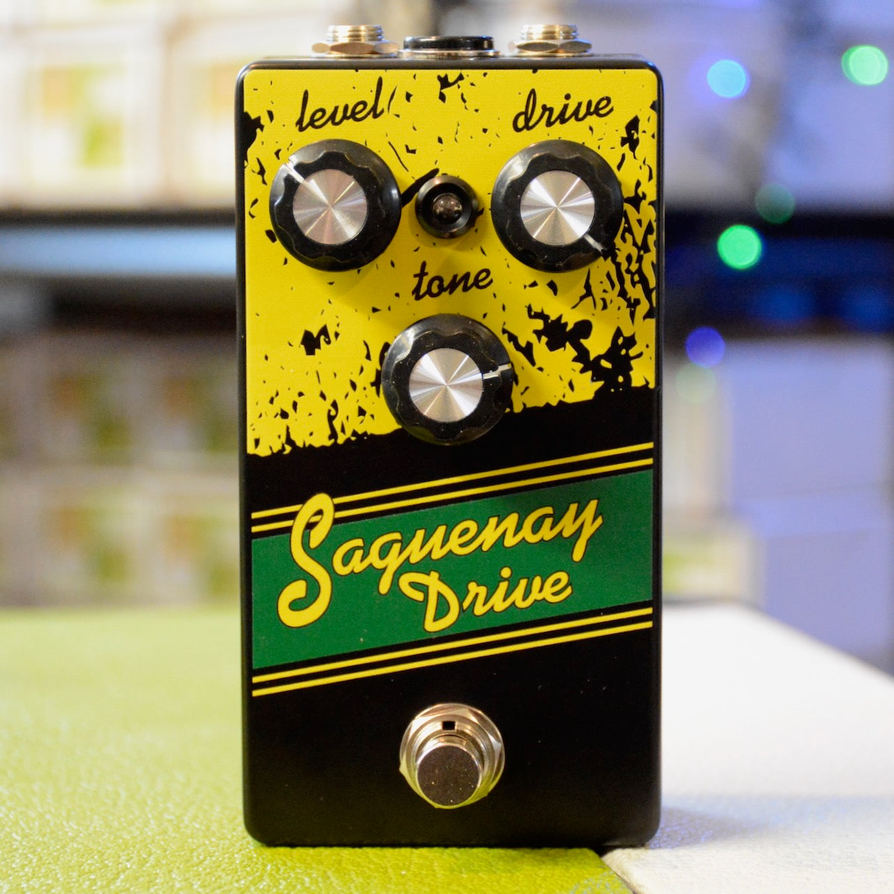 Black and yellow guitar effects pedal with three knobs and one footswitch labeled Saguenay Drive.