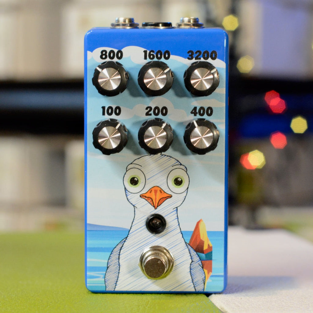 Blue guitar pedal with six numbered knobs and a seagull graphic on the front panel.