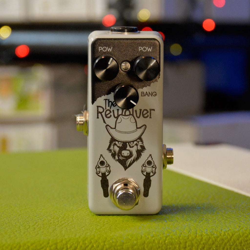 A white guitar effects pedal named The Rewolver with three black knobs and a footswitch.