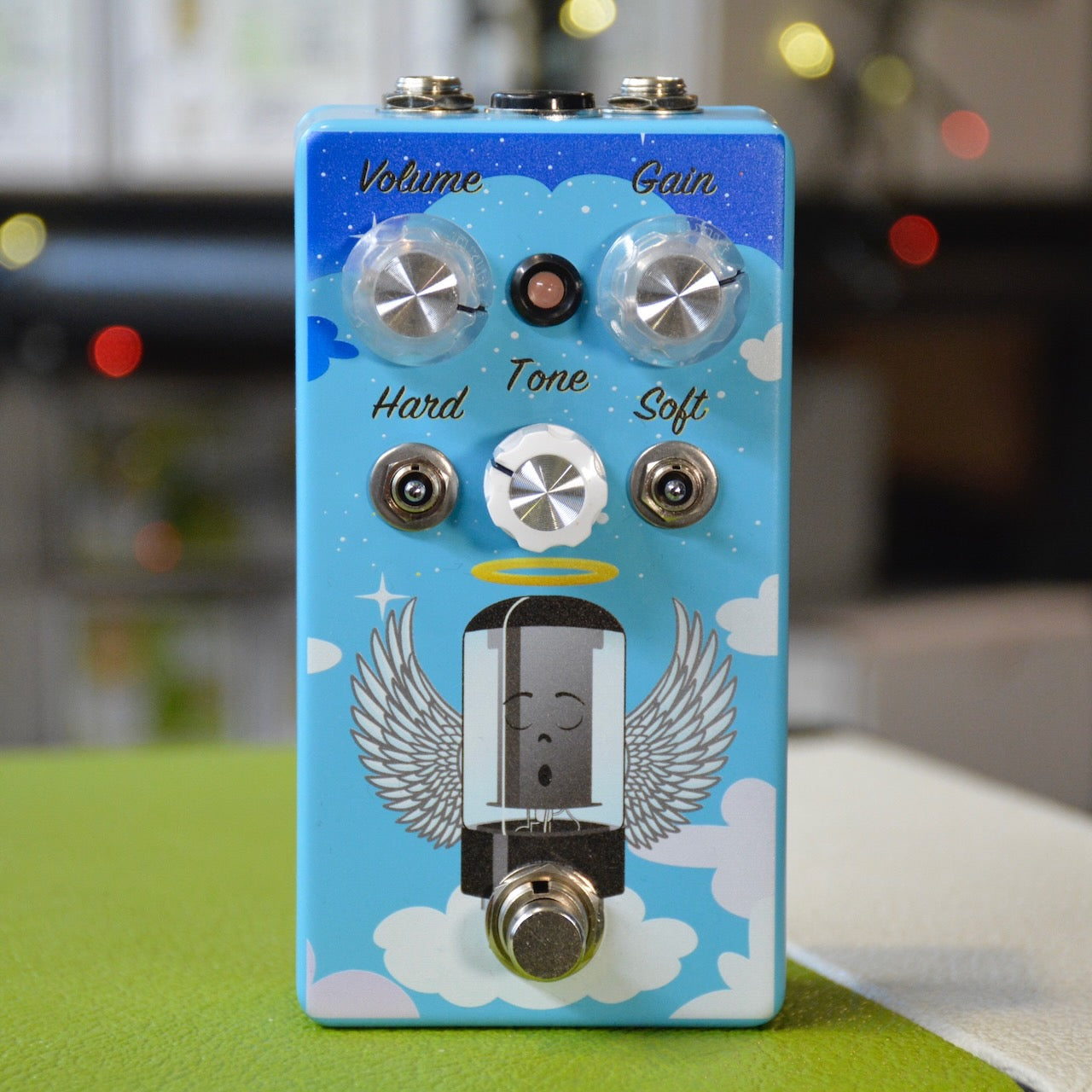 Blue guitar effects pedal with volume, gain, tone knobs and toggle switches labeled Hard and Soft