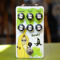 White guitar effects pedal with six control knobs, footswitch, cartoon banana graphic, and 'Bouh!' text.