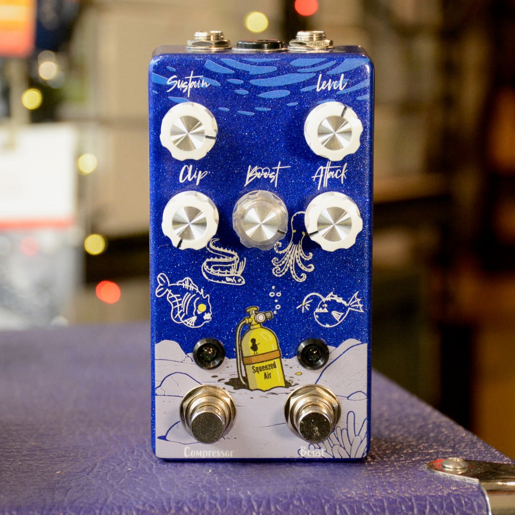 Blue guitar effects pedal with six control knobs, two footswitches, and underwater-themed artwork.