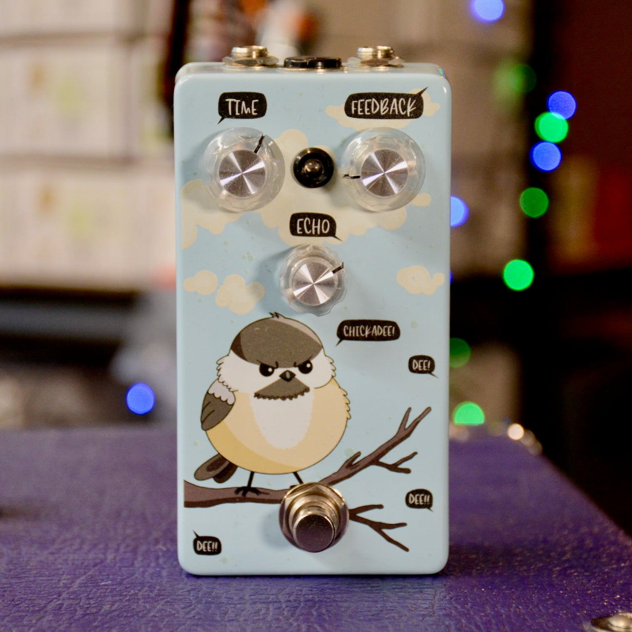 Light blue guitar pedal with bird illustration and labeled knobs for Time, Feedback, and Echo with a footswitch.