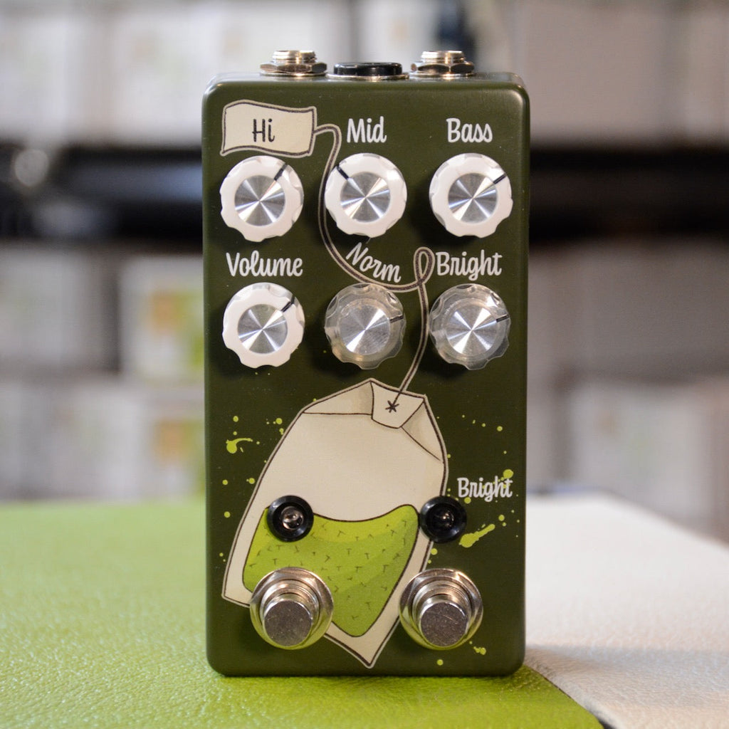 Green guitar effects pedal with six control knobs, two toggle switches, and two footswitches on front panel