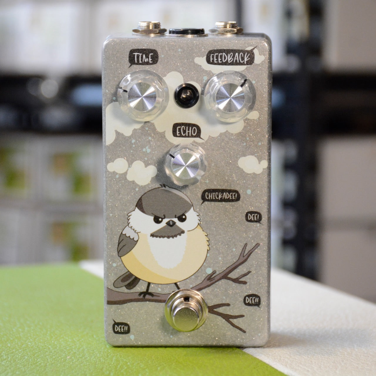 Guitar effects pedal with cartoon bird artwork and three control knobs labeled Time, Feedback, and Echo.