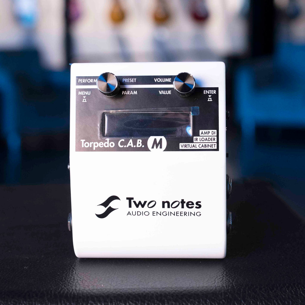 White Two notes Torpedo C.A.B. M audio equipment with two knobs and a display screen.