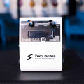 White Two notes Torpedo C.A.B. M audio equipment with two knobs and a display screen.