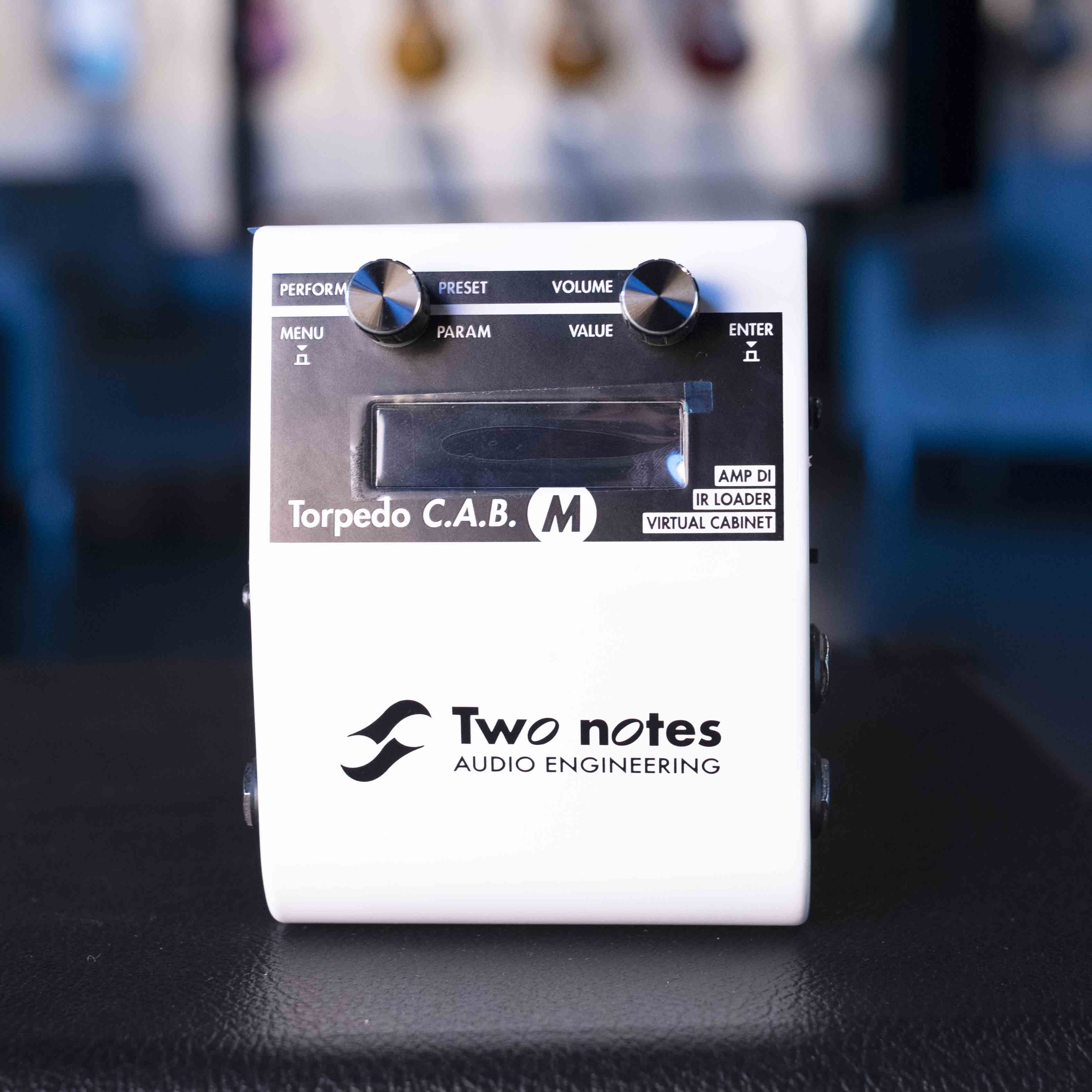 White Two notes Torpedo C.A.B. M audio equipment with two knobs and a display screen.