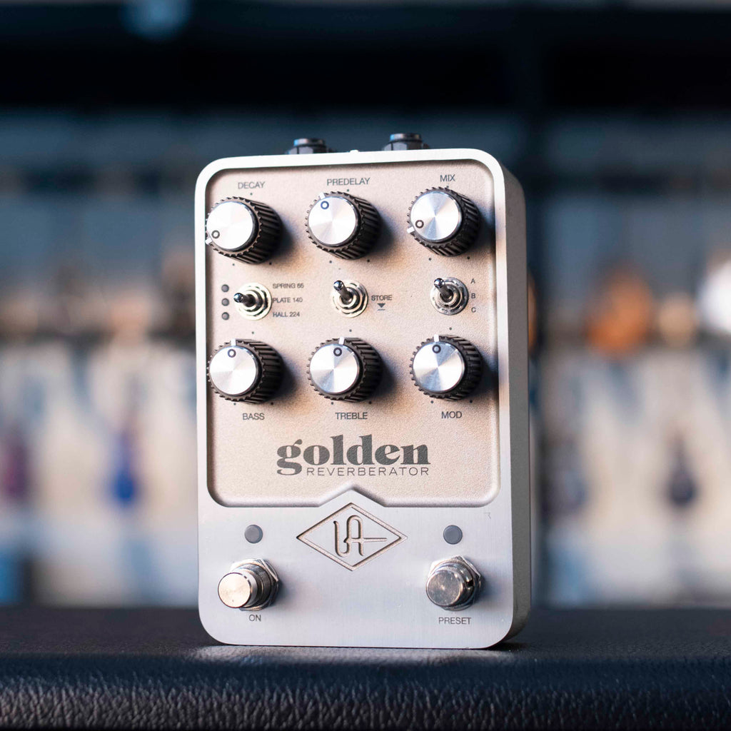 Silver guitar effects pedal with multiple knobs, toggle switches, and two foot switches, labeled 'golden reverberator'.